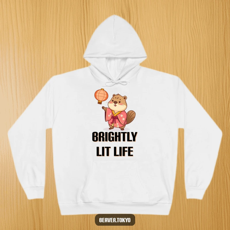 Beaver in a brightly colored kimono playfully tosses a paper lantern, soft and warm hoodie, festive and humorous design, gift.